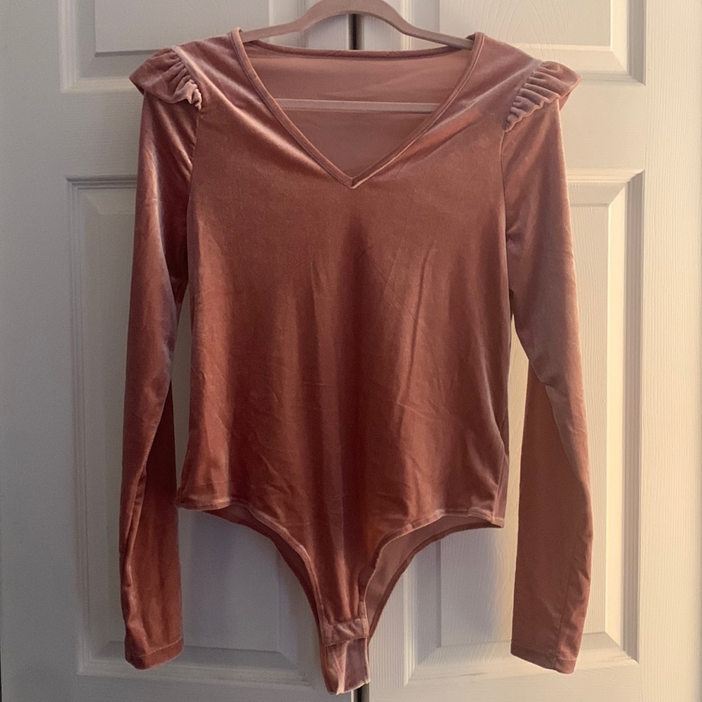Pink velvet bodysuit. Ruffle detail. 2 button closure.